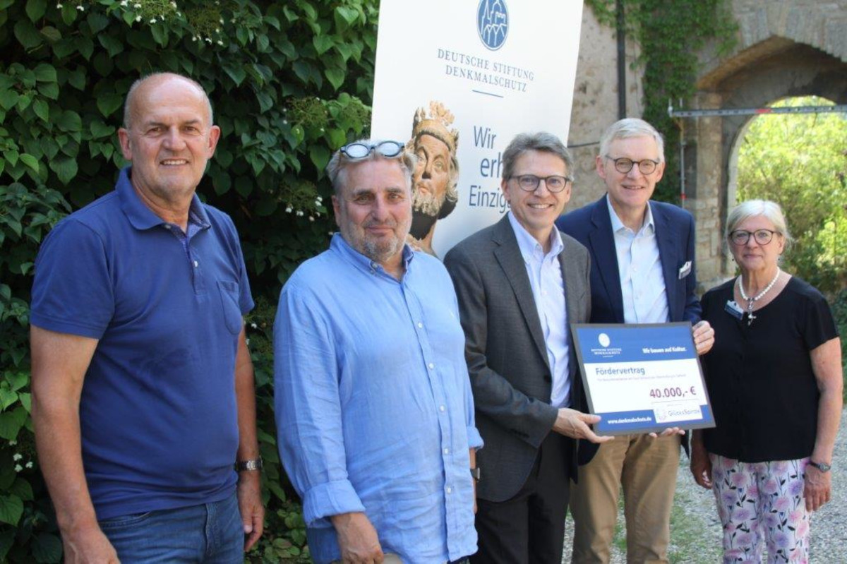 Lotto BW-Regionalleiter Christoph Grüber und Claus Brechter von der DSD überreichen den Förderbescheid an Bürgermeister Rainer Gräßle.